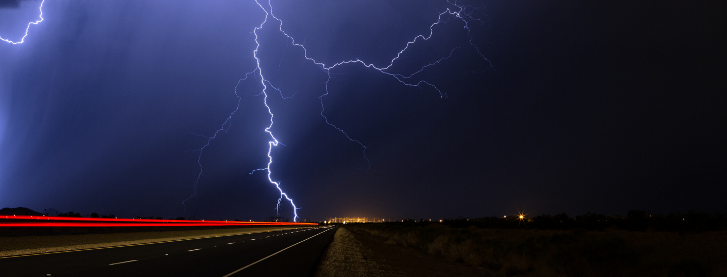 lightning striking on an empty highway